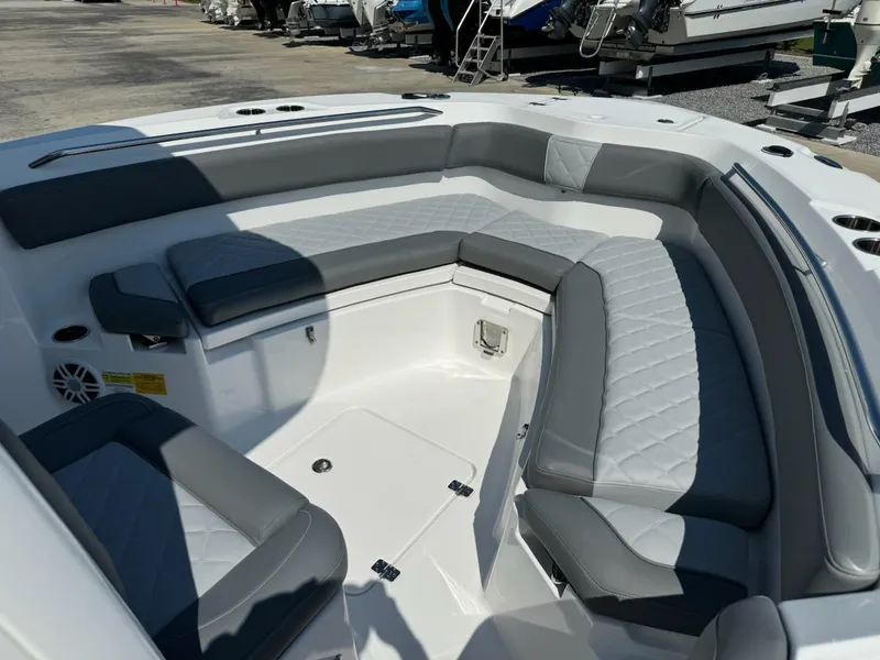 Slide: The Image of 2025 NauticStar 242L Offshore boat interior with gray seating and spacious layout. - 24