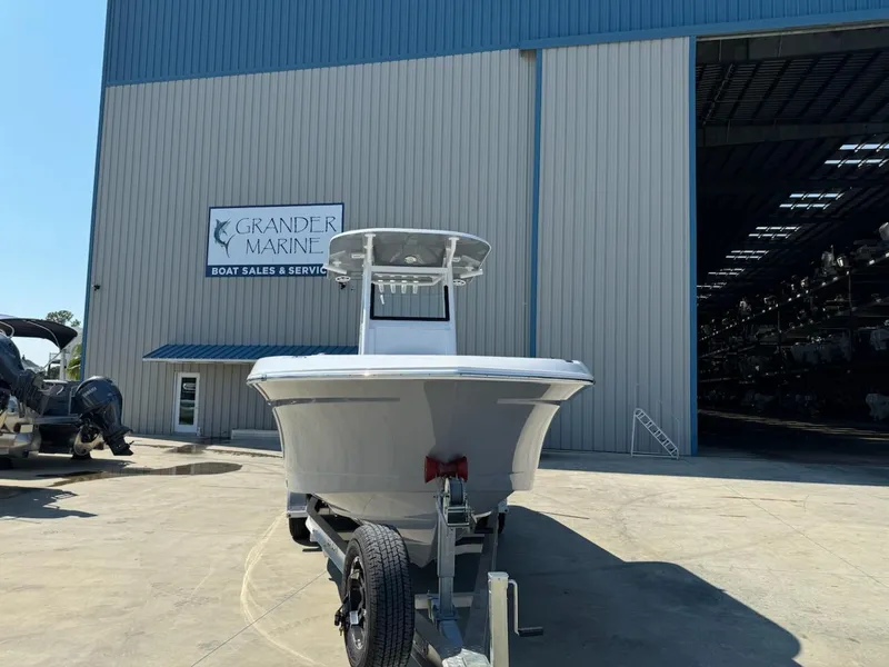 Slide: The Image of 2025 NauticStar 242L Offshore boat on trailer at Grander Marine dealership. - 3