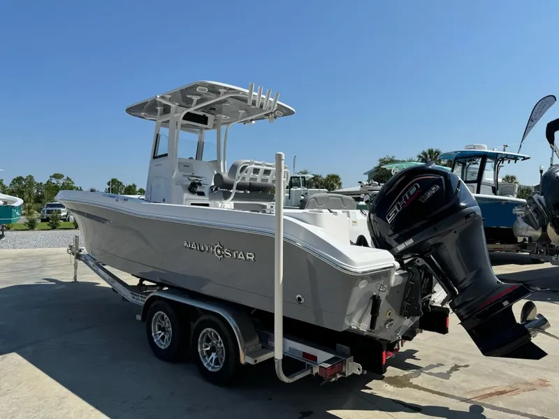 Slide: The Image of 2025 NauticStar 242L Offshore boat on trailer, featuring powerful outboard motor. - 6