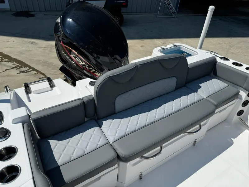 Slide: The Image of 2025 NauticStar 242L Offshore boat with cushioned seating and powerful outboard motor. - 7