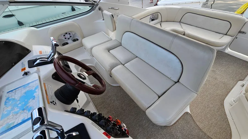 Slide: The Image of 2000 Chris-Craft 328 Express Cruiser interior with white seating and control panel. - 11