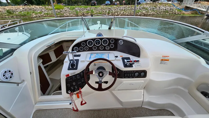Slide: The Image of Cockpit of 2000 Chris-Craft 328 Express Cruiser with steering wheel and control panel. - 13