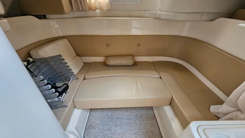 Slide: The Image of 2000 Chris-Craft 328 Express Cruiser interior with beige seating and carpeted floor. - 22