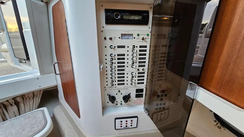 Slide: The Image of Control panel of 2000 Chris-Craft 328 Express Cruiser with switches and audio system. - 29