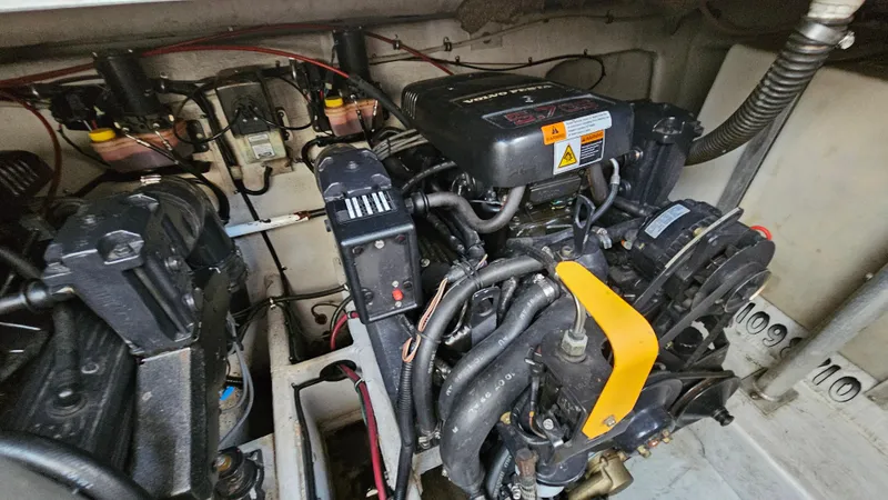 Slide: The Image of Engine compartment of a 2000 Chris-Craft 328 Express Cruiser, showcasing mechanical components and wiring. - 32