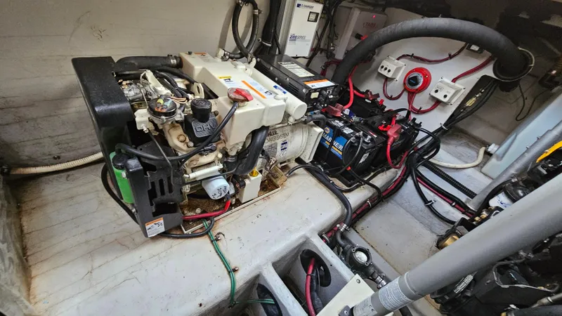 Slide: The Image of Engine room of a 2000 Chris-Craft 328 Express Cruiser, showcasing mechanical components and wiring. - 33