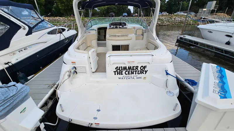 Slide: The Image of 2000 Chris-Craft 328 Express Cruiser docked, rear view with "Summer of the Century" text. - 4