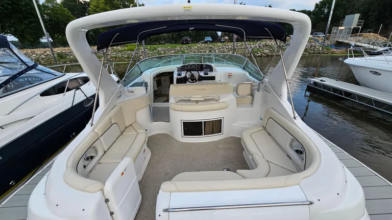 Slide: The Image of 2000 Chris-Craft 328 Express Cruiser with spacious seating, docked at a marina. - 5