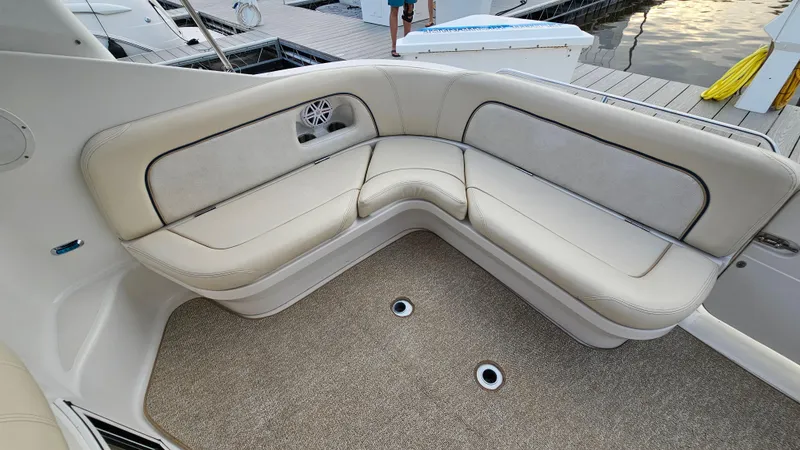 Slide: The Image of 2000 Chris-Craft 328 Express Cruiser interior with beige seating and carpeted floor. - 8