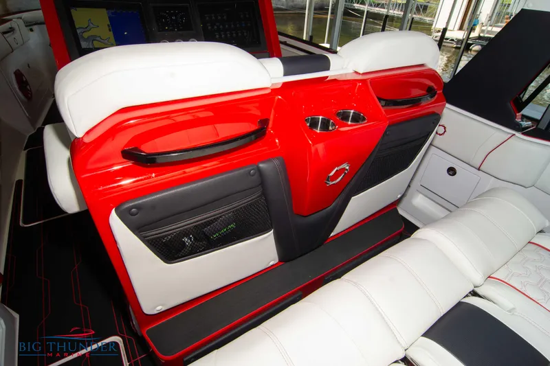 Slide: The Image of 2024 Fountain 38 SCX boat interior with red and white seating and cup holders. - 33