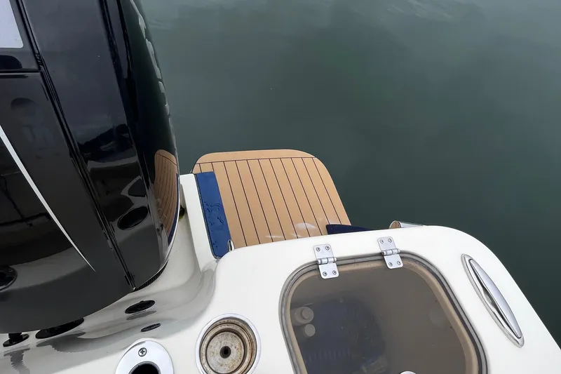 Slide: The Image of 2018 Scout 255 LXF boat stern with teak swim platform and engine. - 14