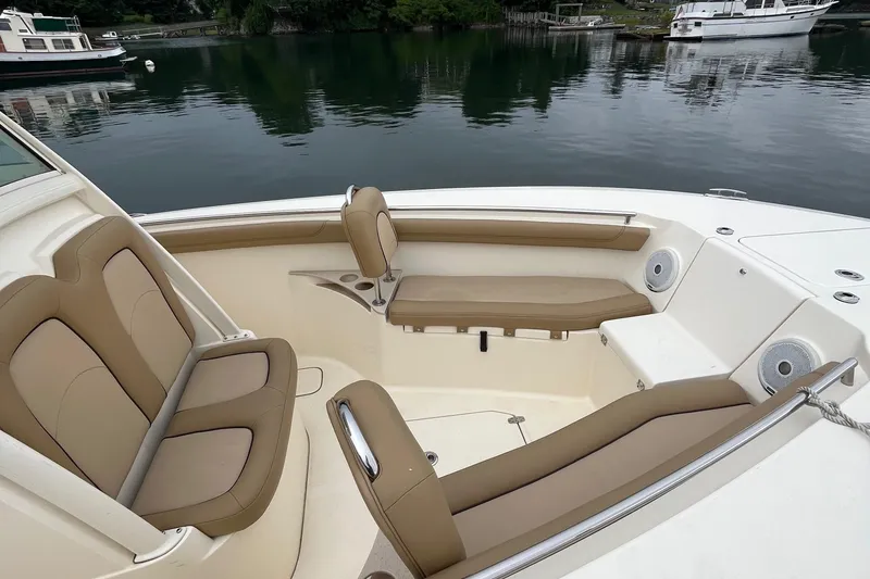 Slide: The Image of 2018 Scout 255 LXF boat interior with tan seating on calm water. - 3