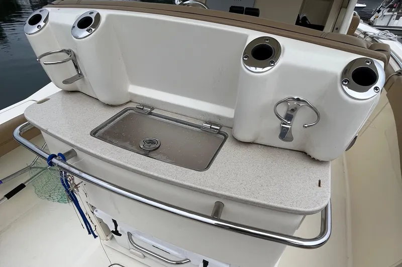 Slide: The Image of 2018 Scout 255 LXF boat with fishing rod holders and sink. - 5