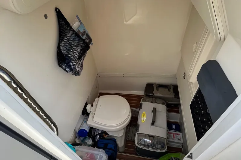 Slide: The Image of 2018 Scout 255 LXF boat interior with toilet and storage compartments. - 9