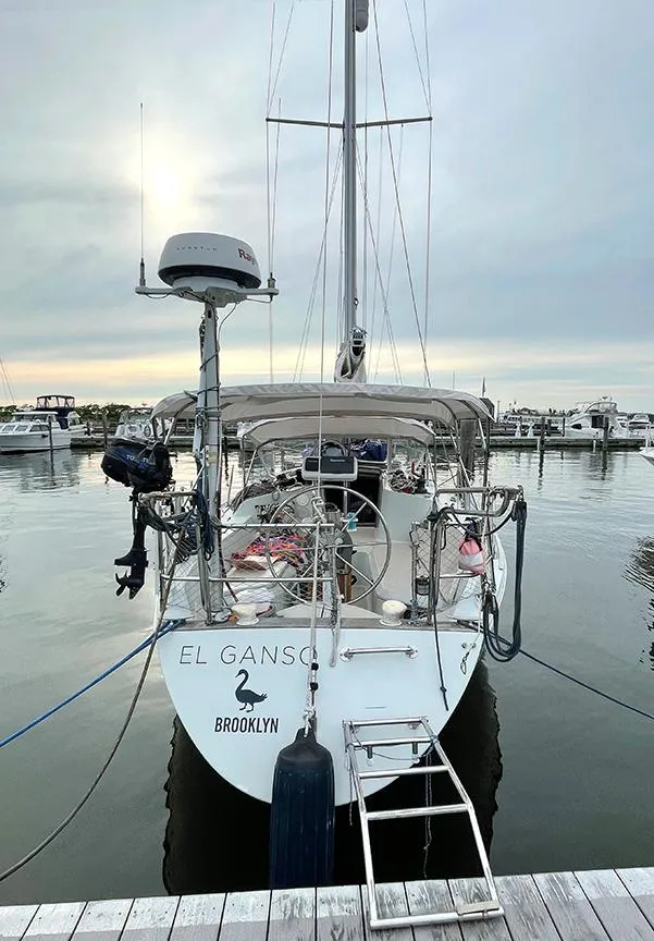 Slide: The Image of Sailboat "El Ganso" docked, Ericson 38-200, 1990 model, serene marina setting. - 1