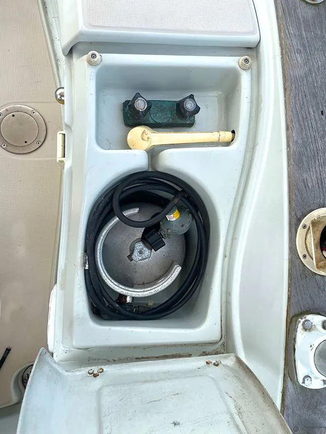 Slide: The Image of Storage compartment on a 1990 Ericson 38-200 sailboat with coiled cable and fittings. - 10