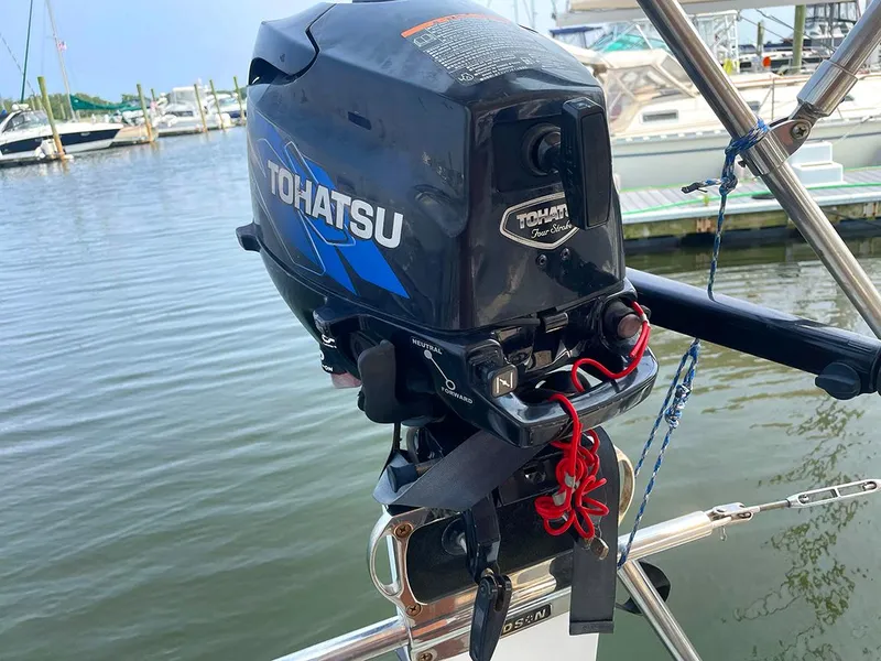 Slide: The Image of Tohatsu outboard motor on Ericson 38-200 sailboat, docked at marina, 1990 model. - 11
