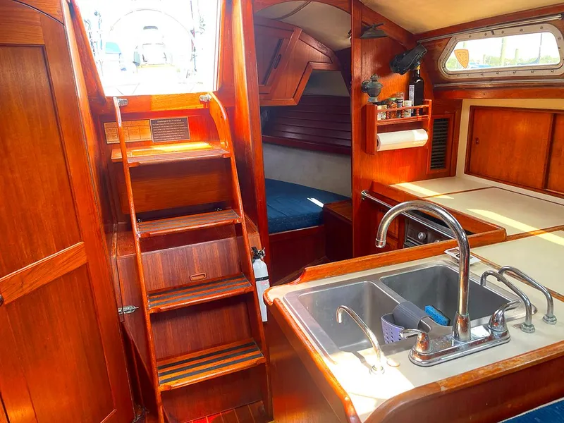 Slide: The Image of Interior of 1990 Ericson 38-200 sailboat with wooden cabinetry and kitchen sink. - 13
