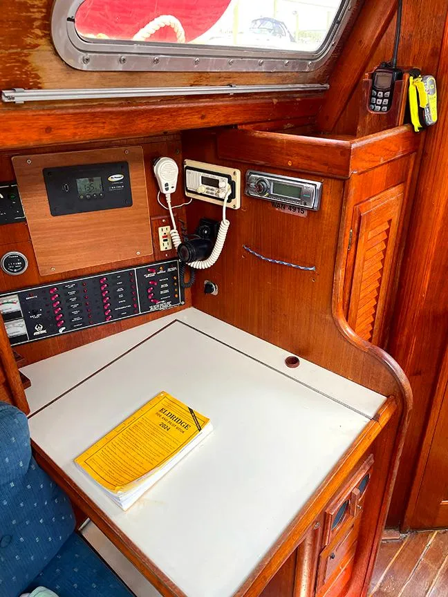 Slide: The Image of Navigation station on 1990 Ericson 38-200 sailboat with communication equipment and manual. - 17
