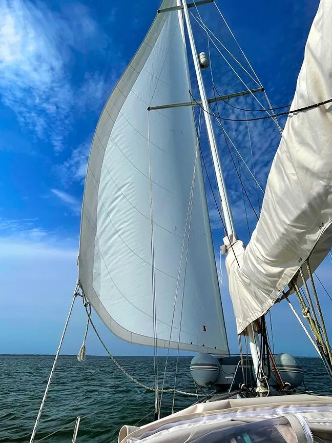 Slide: The Image of Sailing on a 1990 Ericson 38-200 yacht with full sails under a clear blue sky. - 2