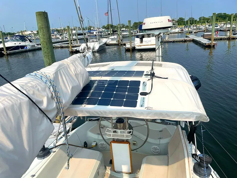 Slide: The Image of Ericson 38-200 sailboat, 1990 model, with solar panels, docked at a marina. - 5