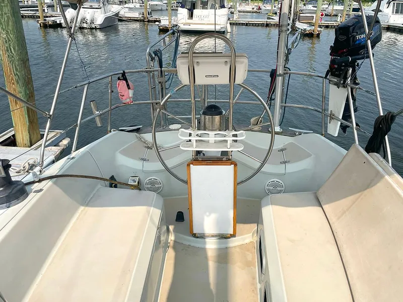 Slide: The Image of Cockpit of a 1990 Ericson 38-200 sailboat docked at a marina. - 7