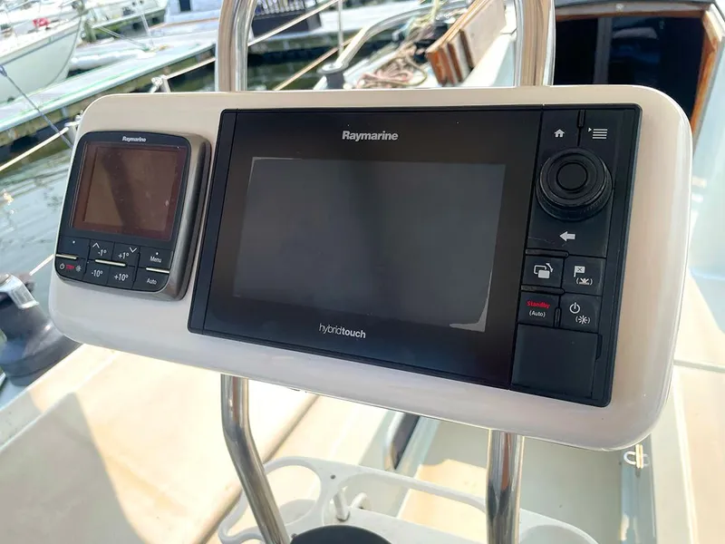 Slide: The Image of Cockpit navigation system on a 1990 Ericson 38-200 sailboat, featuring Raymarine and Panasonic displays. - 9