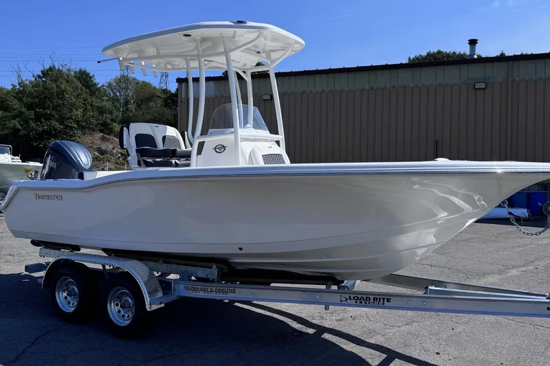 Slide: The Image of 2025 Tidewater 210 CC Adventure boat on trailer, parked outdoors. - 0
