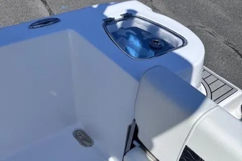 Slide: The Image of 2025 Tidewater 210 CC Adventure boat interior with seating and storage compartment. - 7