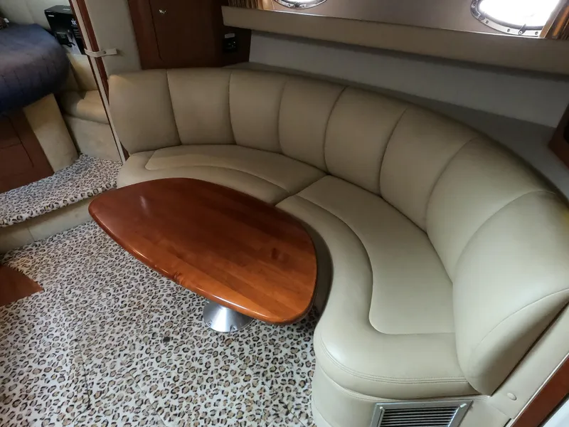 Slide: The Image of Luxurious interior of 2004 Chaparral Signature 350 with curved leather seating and wooden table. - 16