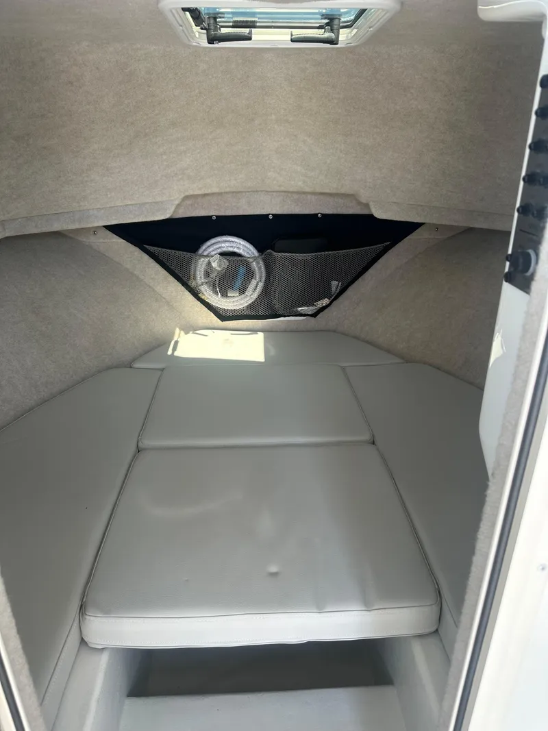 Slide: The Image of 2022 Parker 2520 XLD Sport Cabin interior with cushioned seating and storage net. - 6