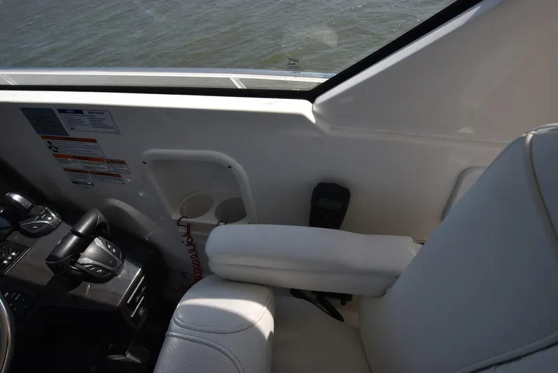 Slide: The Image of Interior view of 2022 Pursuit OS 355 Offshore boat cockpit with controls and seating. - 11