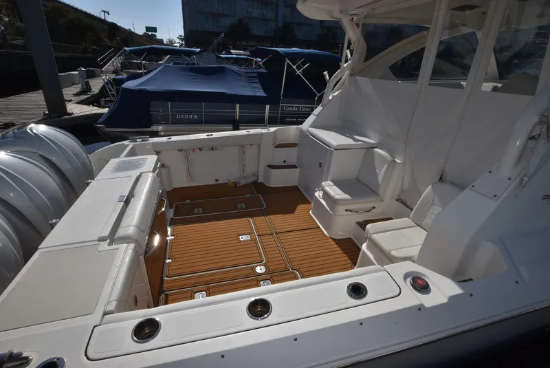 Slide: The Image of 2022 Pursuit OS 355 Offshore boat with spacious deck and seating area. - 12