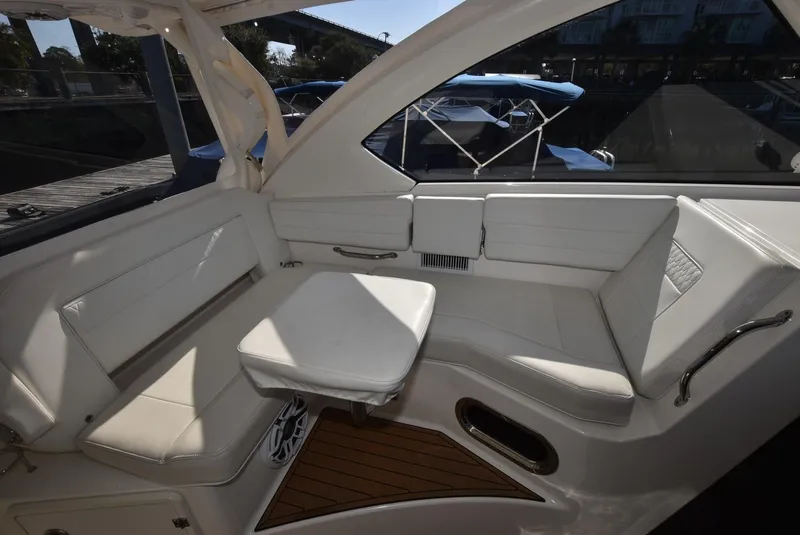 Slide: The Image of 2022 Pursuit OS 355 Offshore boat interior with white seating and table. - 16