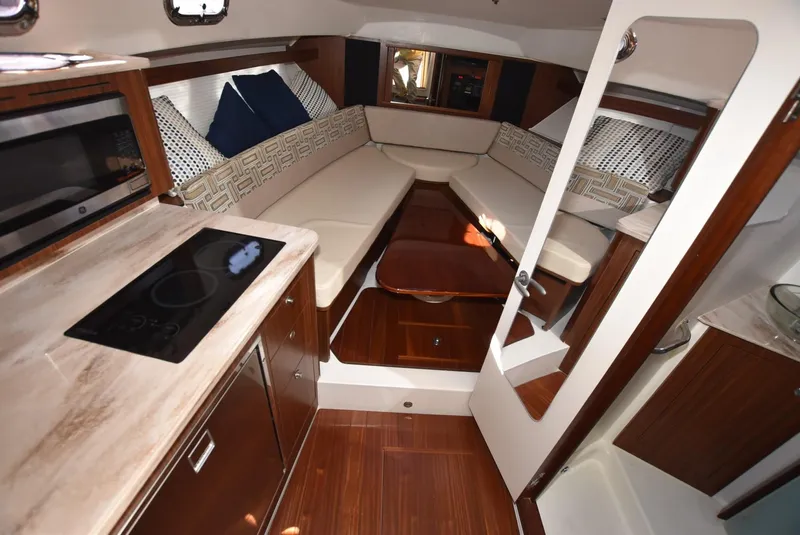 Slide: The Image of 2022 Pursuit OS 355 Offshore cabin interior with modern amenities and cozy seating. - 18