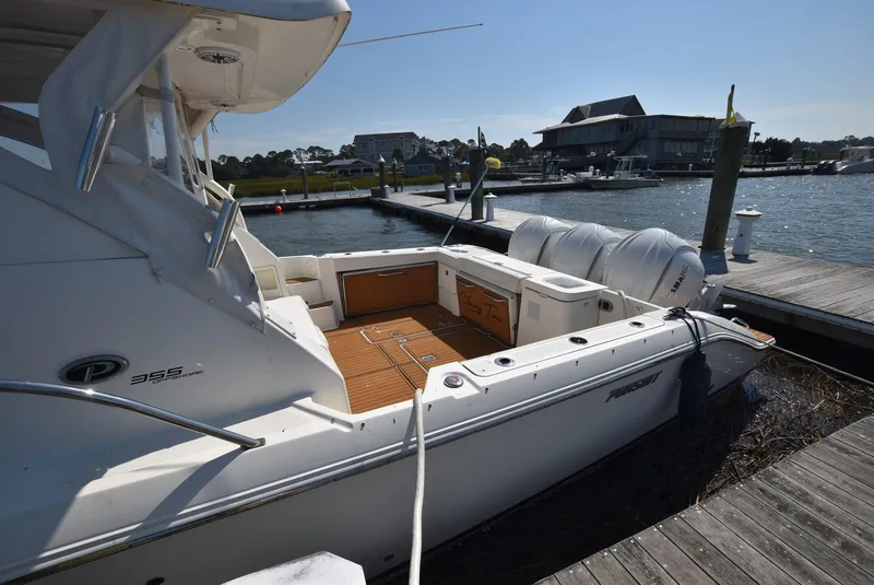 Slide: The Image of 2022 Pursuit OS 355 Offshore boat docked at marina, sunny day. - 3