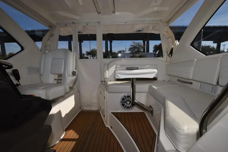 Slide: The Image of Interior of 2022 Pursuit OS 355 Offshore boat with white seating and wood flooring. - 7