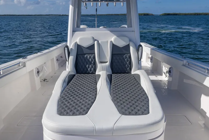 Slide: The Image of 2023 Invincible 35 Catamaran with luxurious seating on open water. - 12