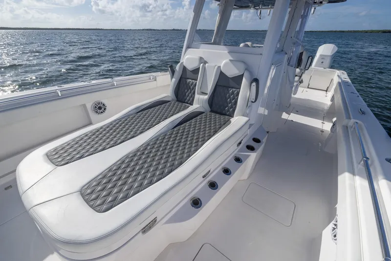 Slide: The Image of 2023 Invincible 35 Catamaran with luxurious seating on open water. - 14