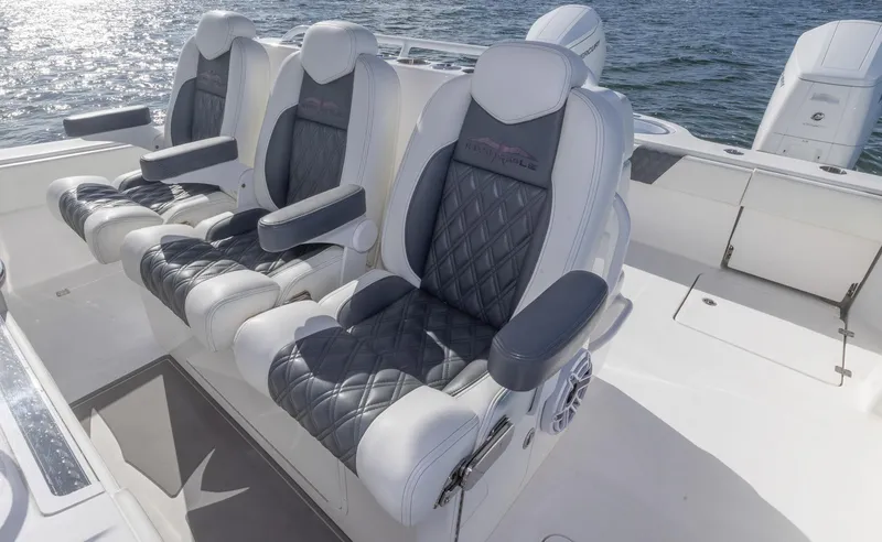 Slide: The Image of Luxurious seating on 2023 Invincible 35 Catamaran, featuring diamond-stitched upholstery and armrests. - 18