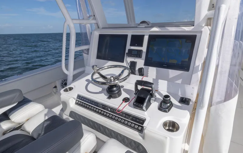 Slide: The Image of Invincible 35 Catamaran 2023 helm with advanced navigation system and ocean view. - 20