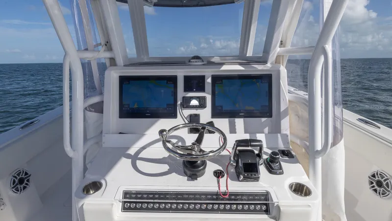 Slide: The Image of 2023 Invincible 35 Catamaran helm with dual screens and ocean view. - 21