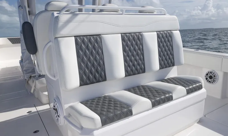 Slide: The Image of 2023 Invincible 35 Catamaran with luxurious diamond-stitched seating on open water. - 23