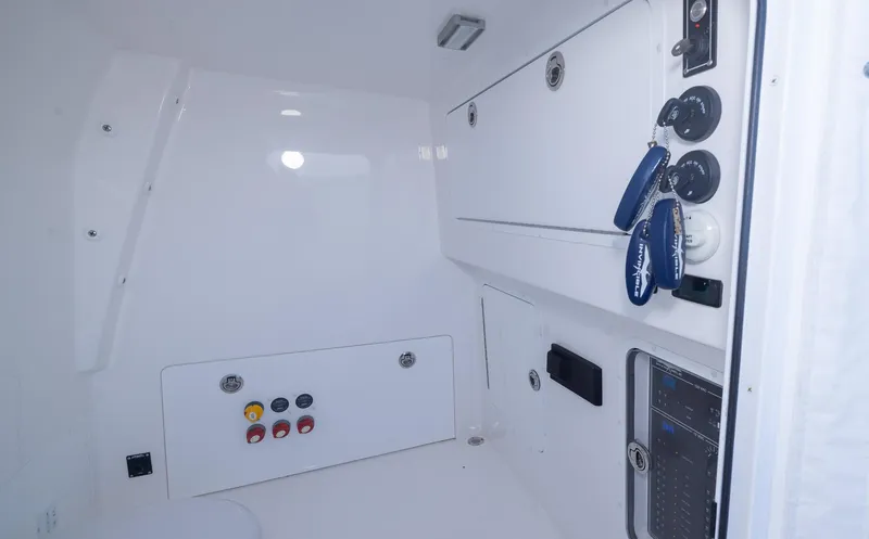 Slide: The Image of 2023 Invincible 35 Catamaran interior with control panel and storage compartments. - 27