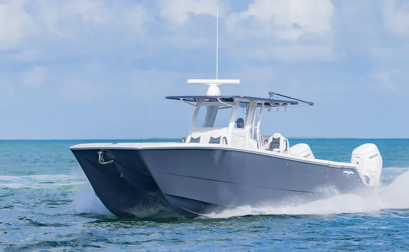 Slide: The Image of 2023 Invincible 35 Catamaran cruising on open water under clear skies. - 40