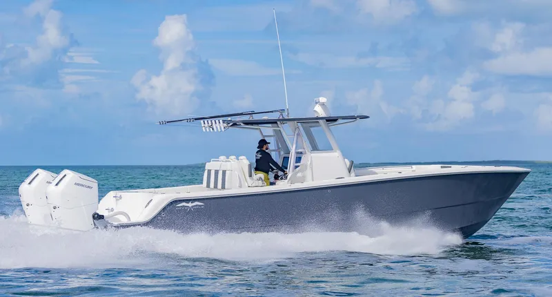 Slide: The Image of 2023 Invincible 35 Catamaran cruising on open water under a clear sky. - 42