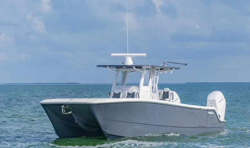 Slide: The Image of 2023 Invincible 35 Catamaran cruising on open water under a clear sky. - 5