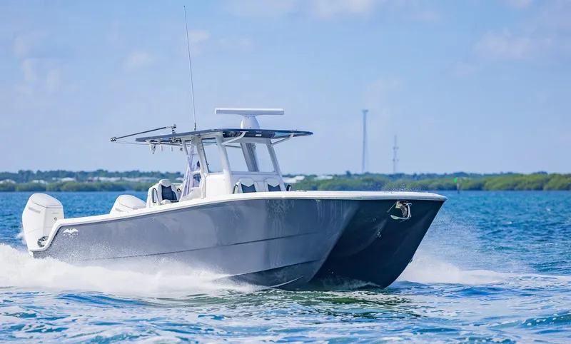 Slide: The Image of 2023 Invincible 35 Catamaran cruising on open water under clear skies. - 6
