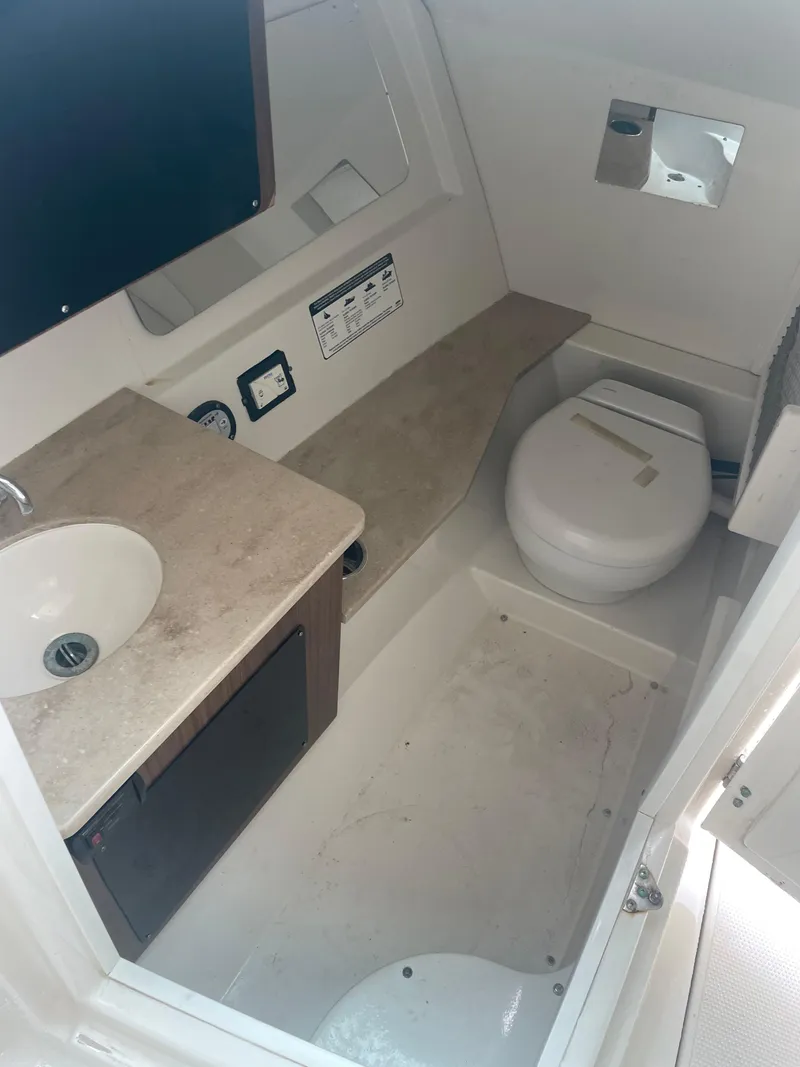 Slide: The Image of 2019 Sailfish 325 Dual Console boat bathroom with sink and toilet. - 25