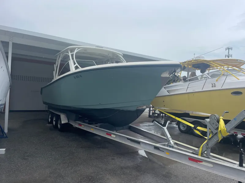 Slide: The Image of 2019 Sailfish 325 Dual Console boat on trailer in storage facility. - 26